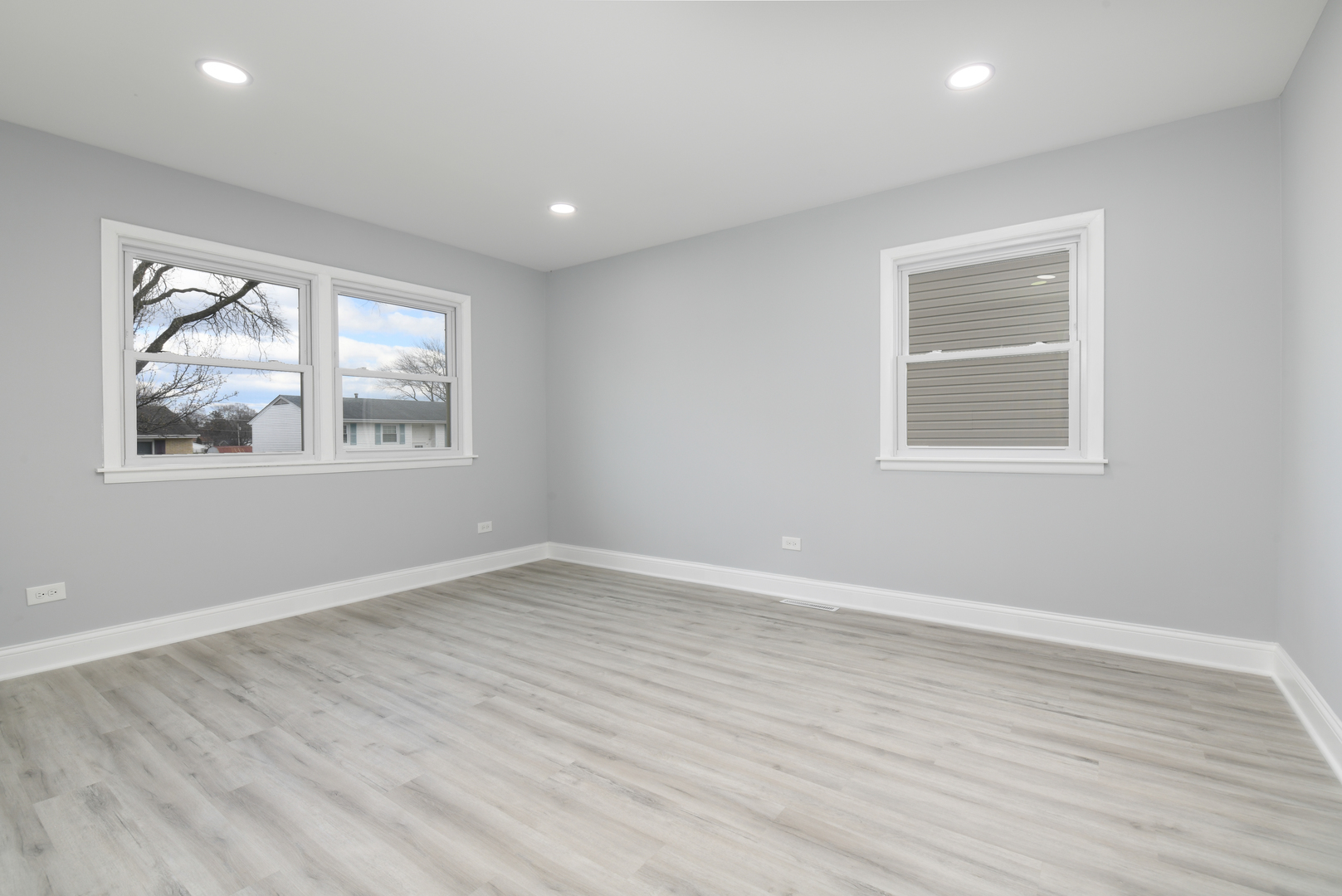 44 Redwood Trail Wheeling, IL 60090 - Photo 9 of 18 an empty room with wooden floor and windows