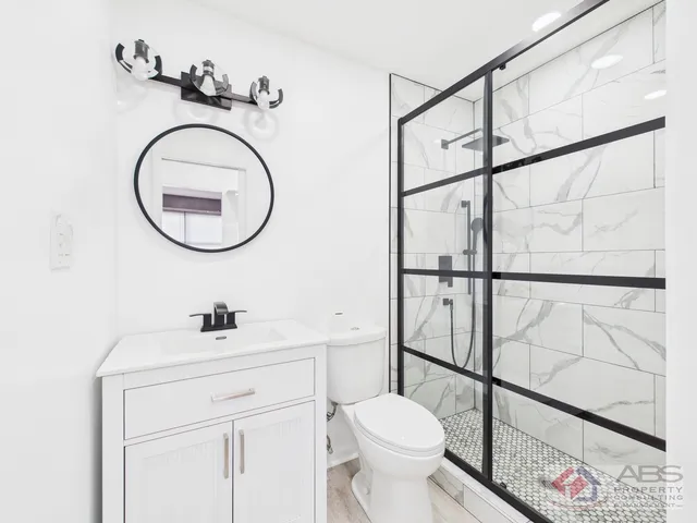 a bathroom with a sink a toilet and a mirror