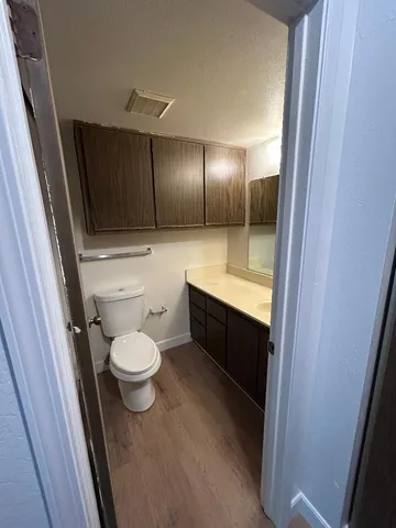 a bathroom with a toilet a sink and mirror