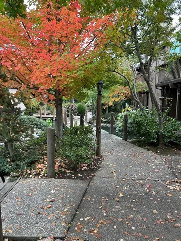 a wooden deck with patio and lake view