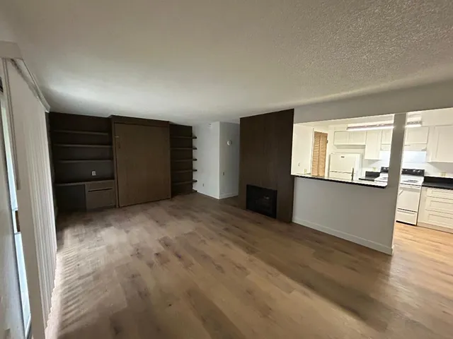 a view of a kitchen with a sink and a refrigerator