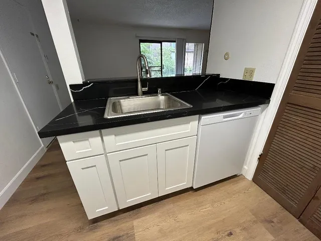 a kitchen with a sink and cabinets
