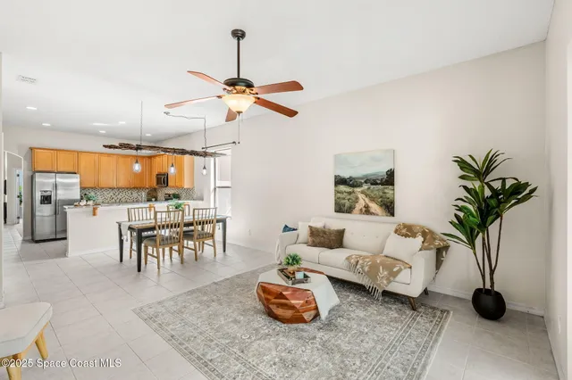 a bedroom with a bed and a chandelier fan