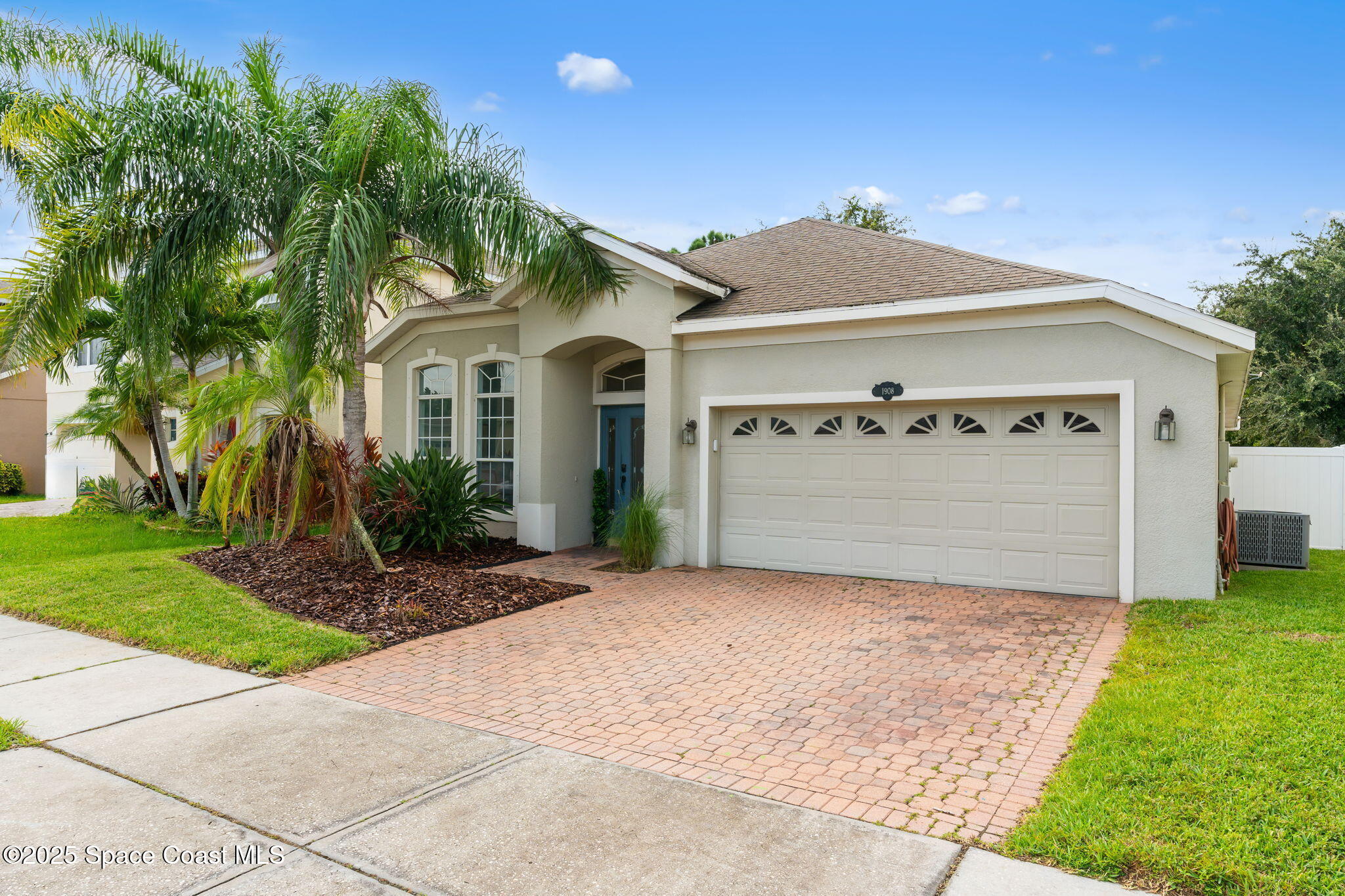 1908 Tullagee Avenue Melbourne, FL 32940 - Photo 2 of 58 a front view of a house with a yard and garage