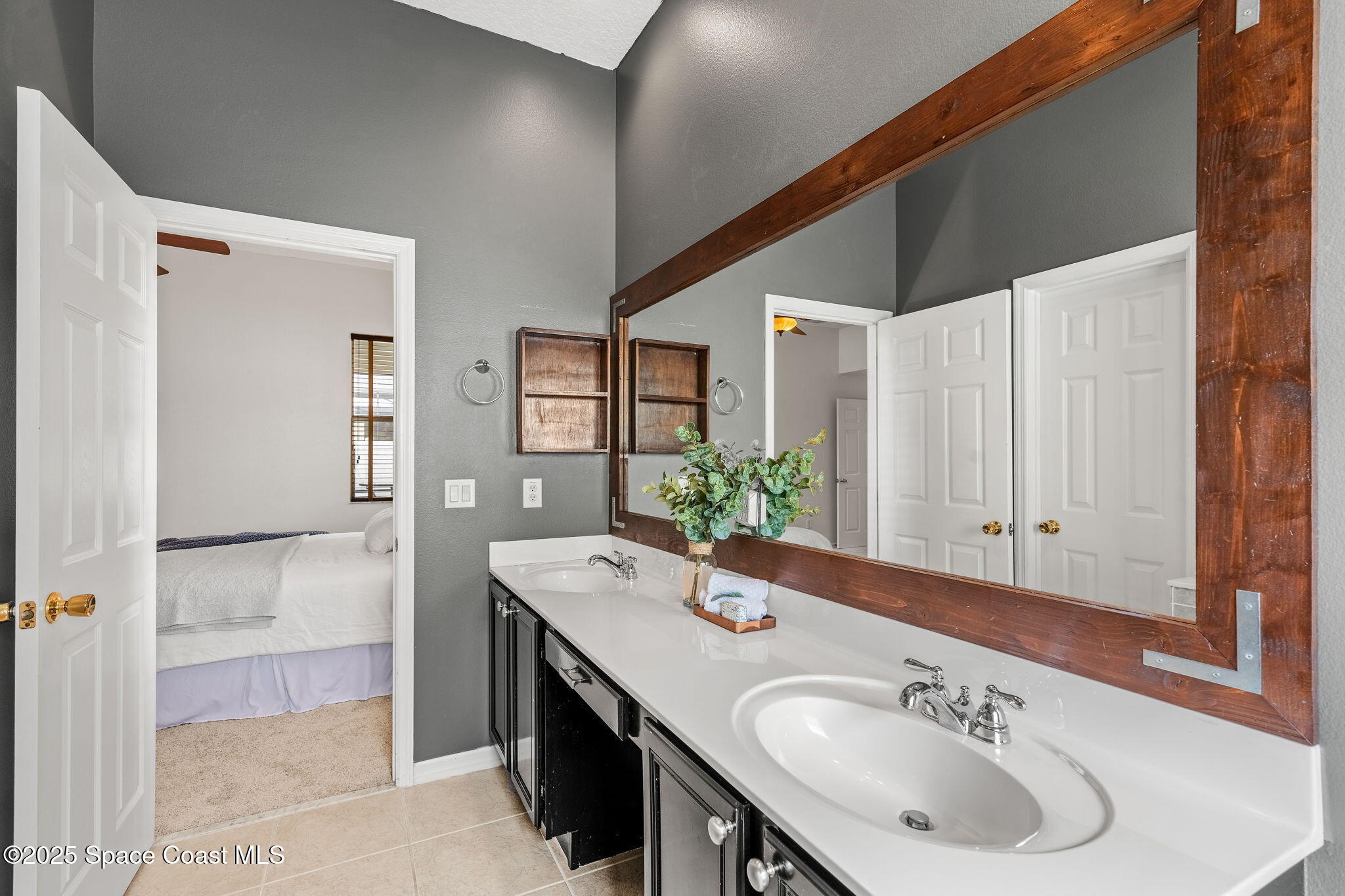 1908 Tullagee Avenue Melbourne, FL 32940 - Photo 25 of 58 a bathroom with a sink and a mirror