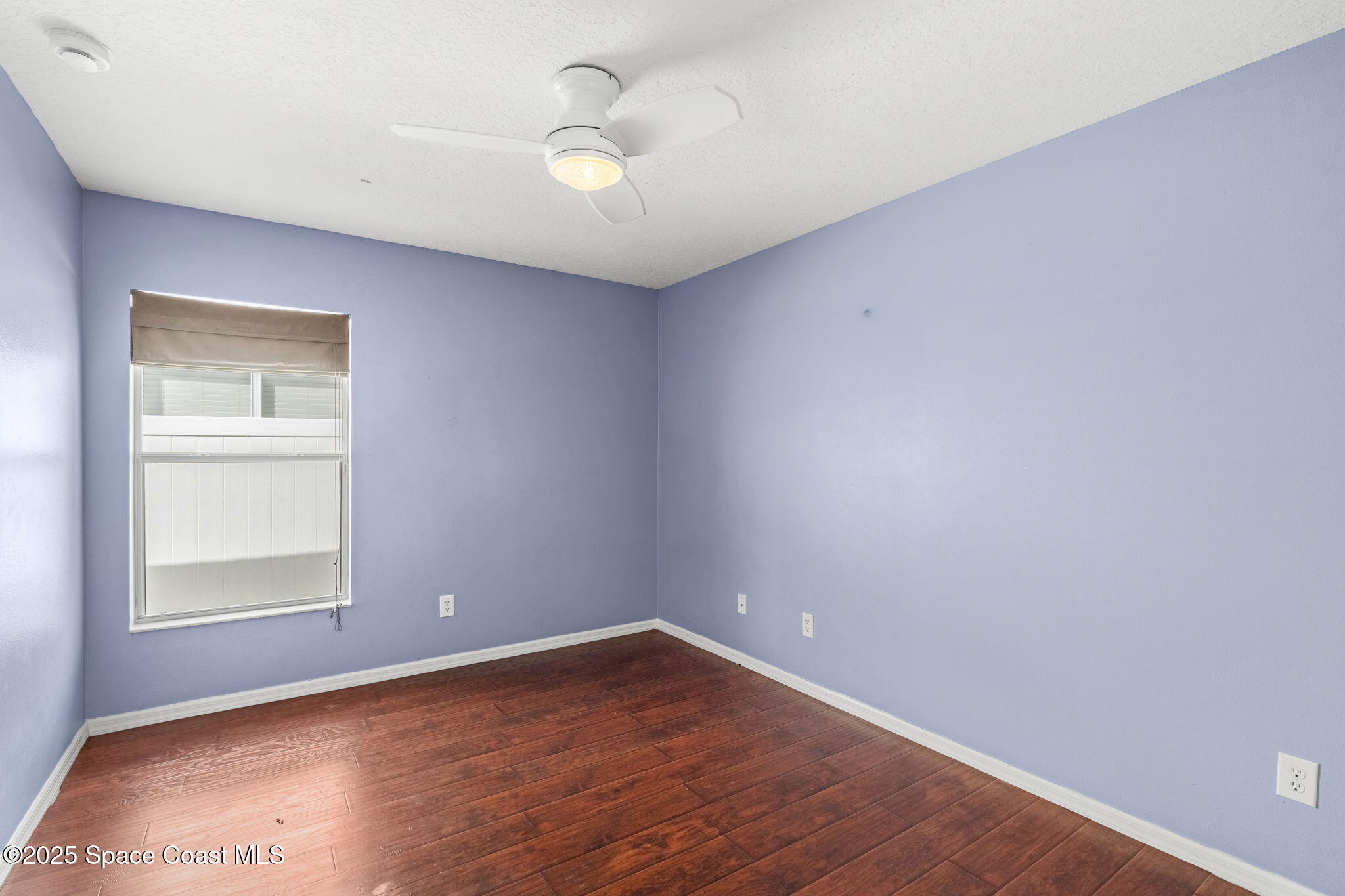 1908 Tullagee Avenue Melbourne, FL 32940 - Photo 27 of 58 an empty room with wooden floor and windows