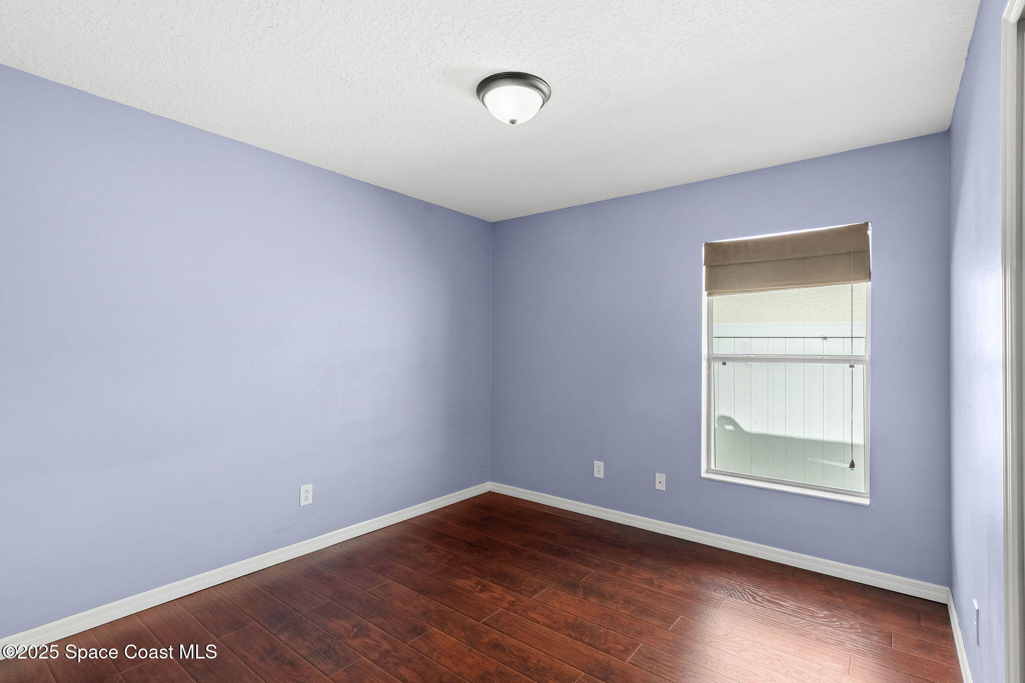 1908 Tullagee Avenue Melbourne, FL 32940 - Photo 29 of 58 a view of an empty room with wooden floor and a window