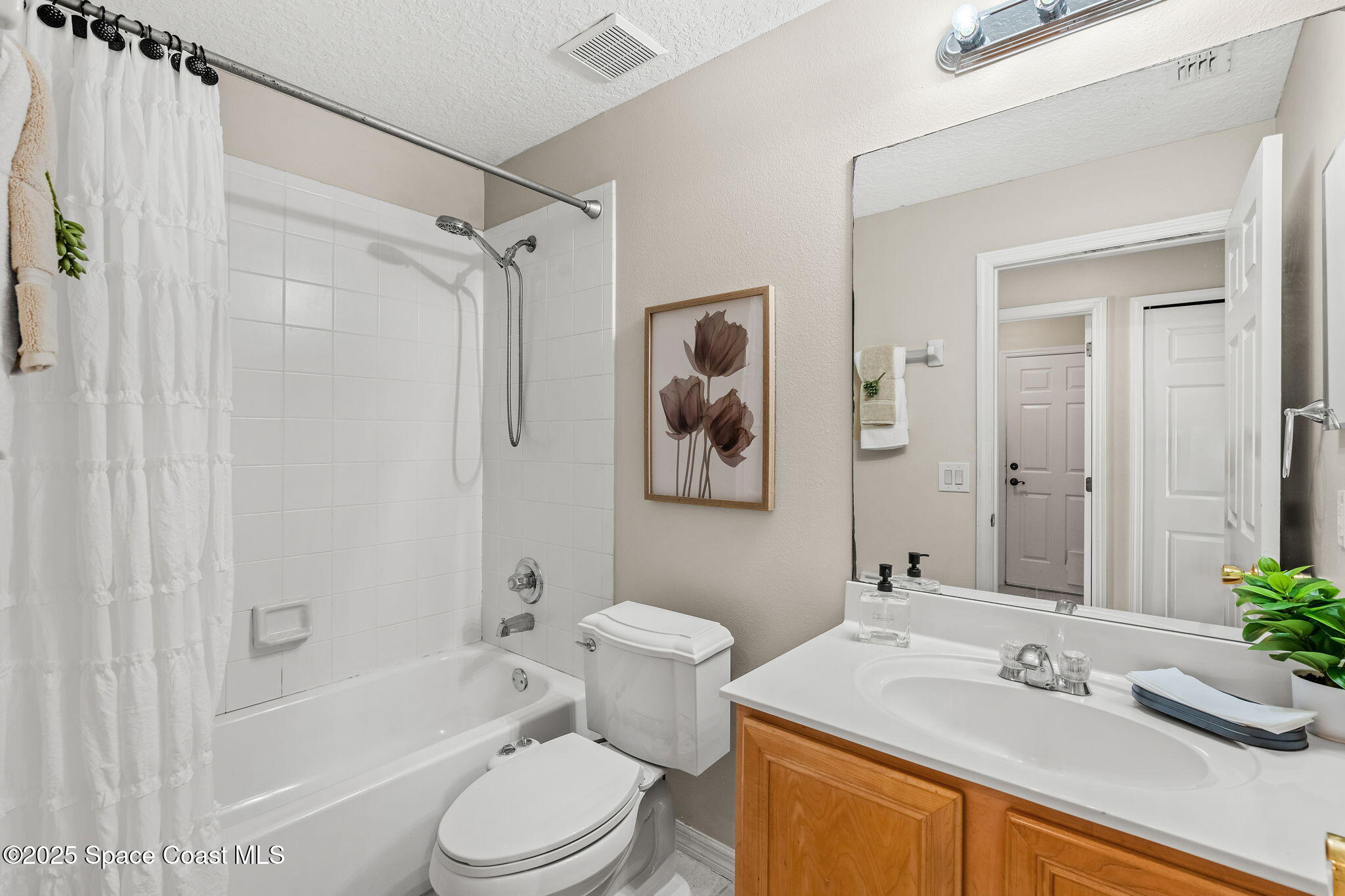 1908 Tullagee Avenue Melbourne, FL 32940 - Photo 30 of 58 a bathroom with a sink toilet and shower