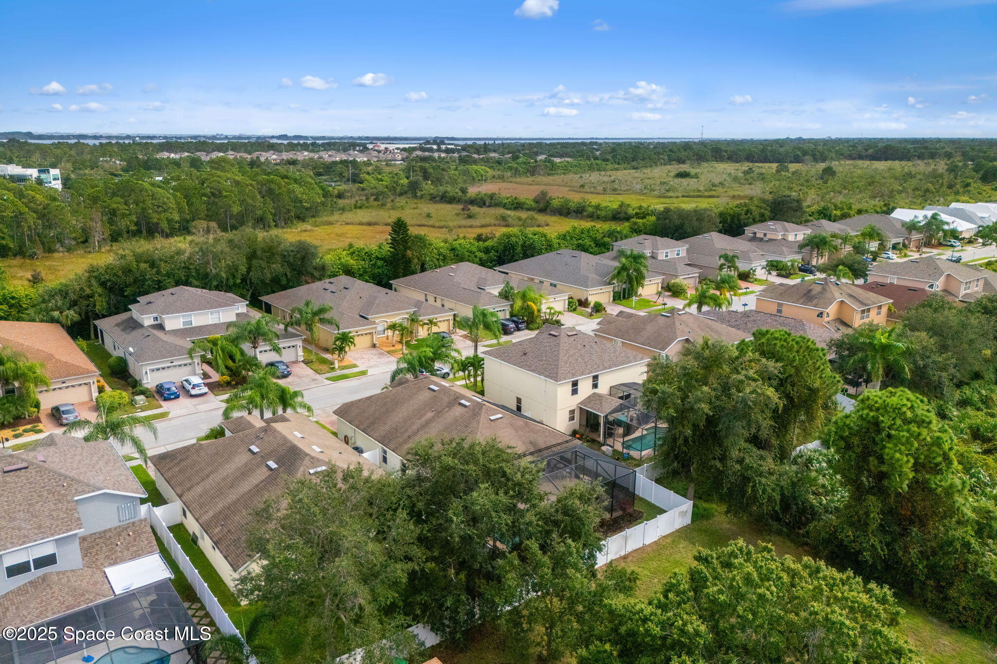 1908 Tullagee Avenue Melbourne, FL 32940 - Photo 42 of 58 an aerial view of a city with lots of residential buildings ocean and mountain view in back