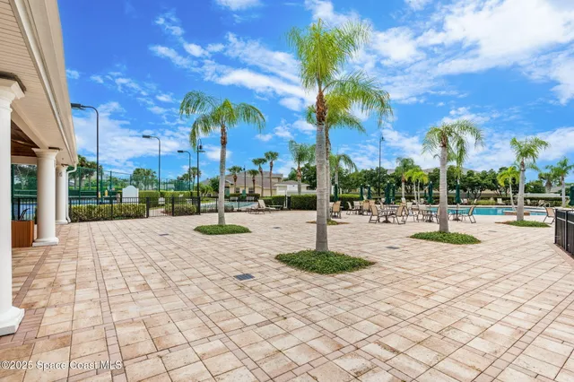 a view of a house with backyard and sitting area