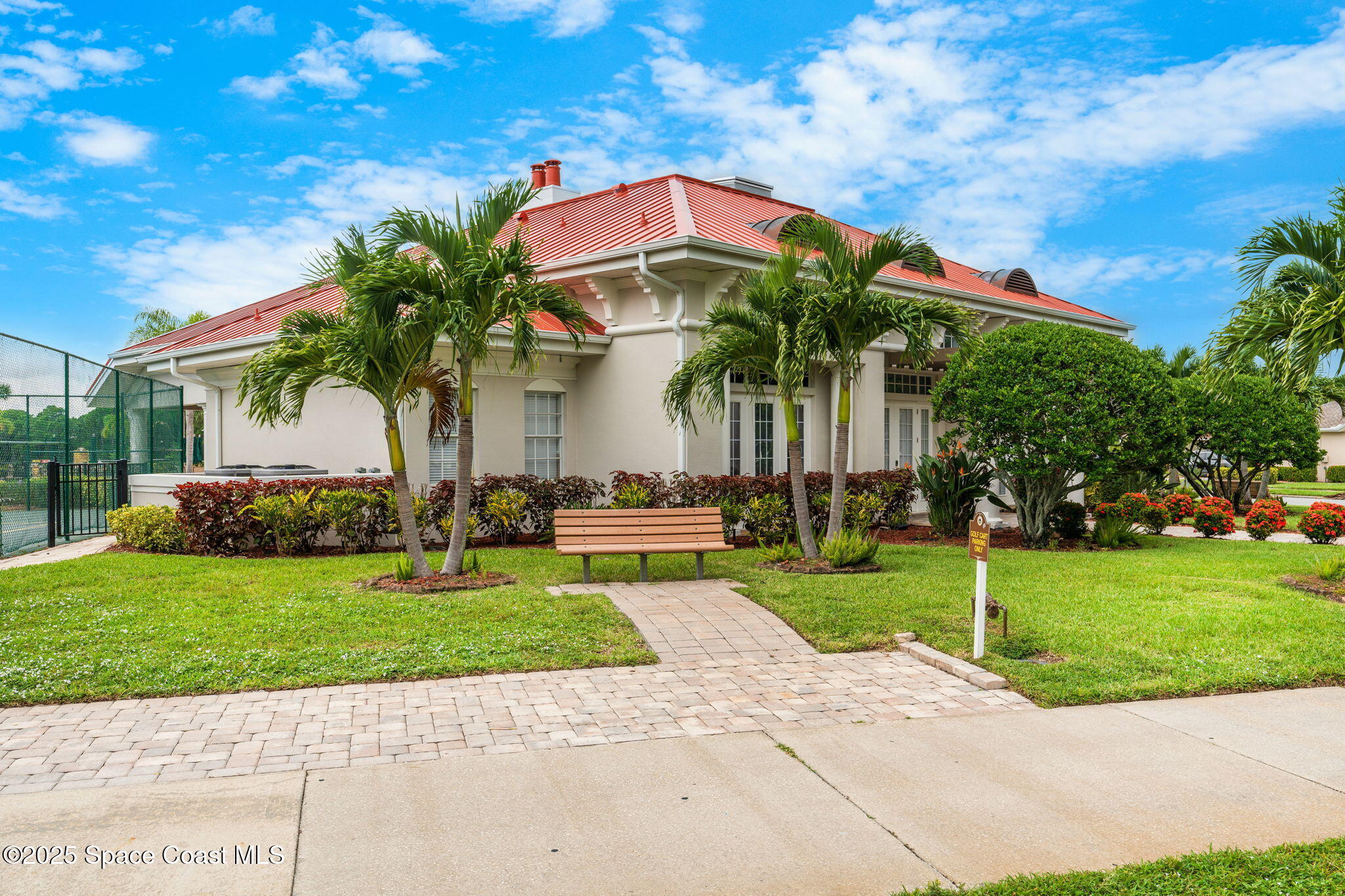 1908 Tullagee Avenue Melbourne, FL 32940 - Photo 54 of 58 a front view of a house with a garden and a yard