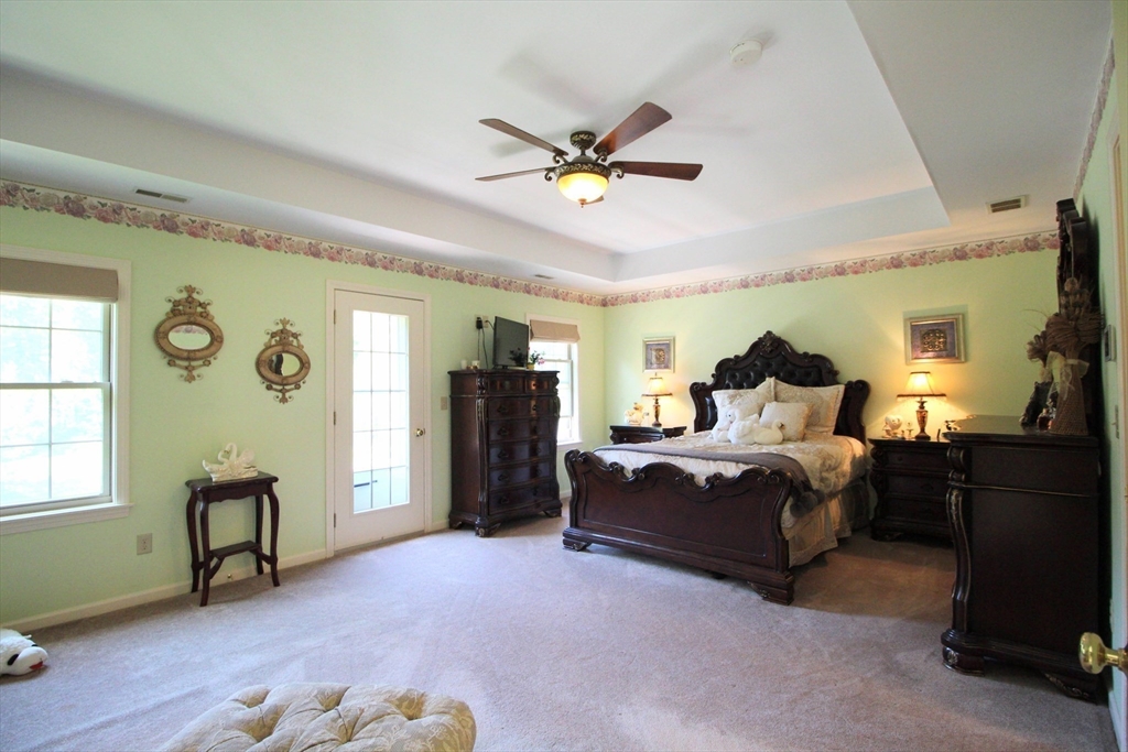 5 Gableview Lane Southwick, MA 01077 - Photo 26 of 41 a bedroom with a bed and a chandelier