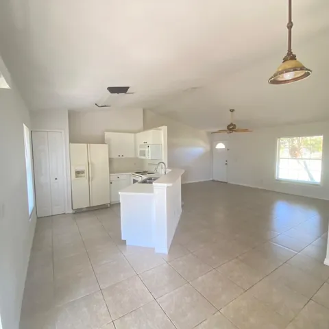 a view of a kitchen with electric appliances