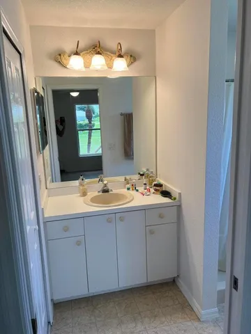 a bathroom with a double vanity sink and a mirror