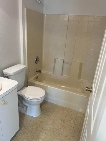 a bathroom with a toilet a sink and a bathtub