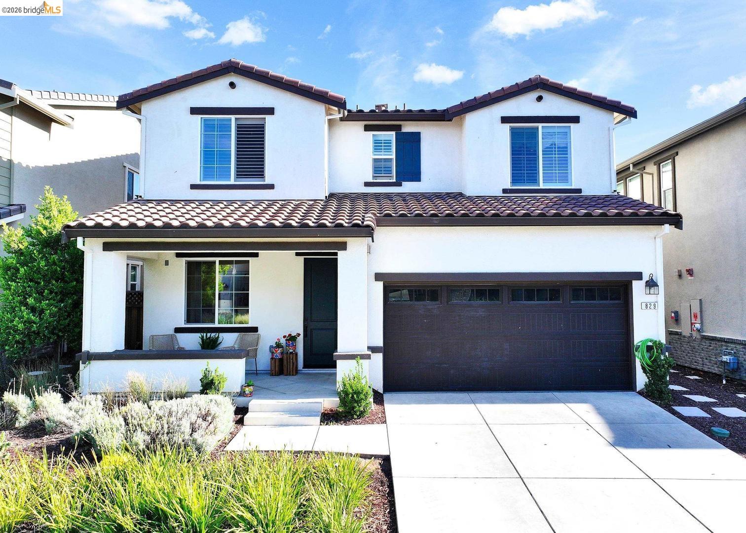 829 Hardcastle Ranch Road Oakley, CA 94561 - Photo 1 of 42 Stucco exterior with dark trim accents, tile roof, attached garage, and a covered front porch