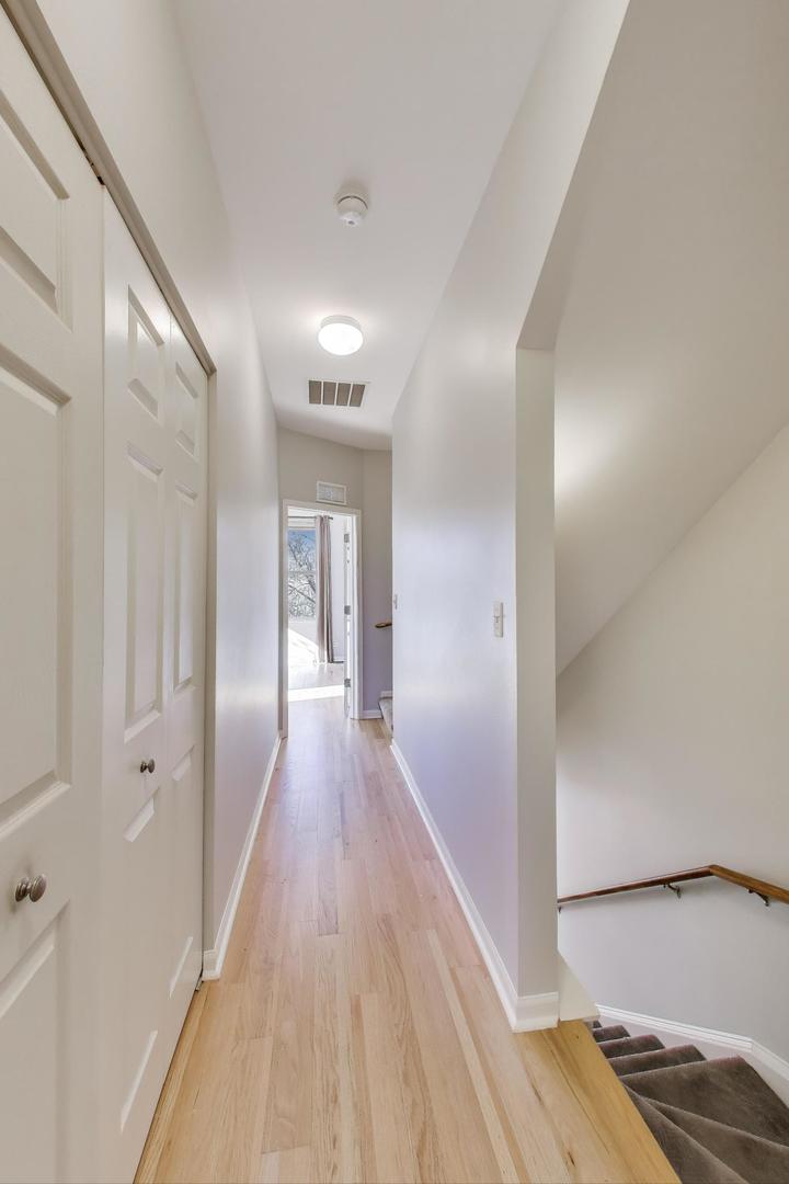 125 North Rose Street, Unit E Palatine, IL 60067 - Photo 12 of 28 a view of a hallway with wooden floor