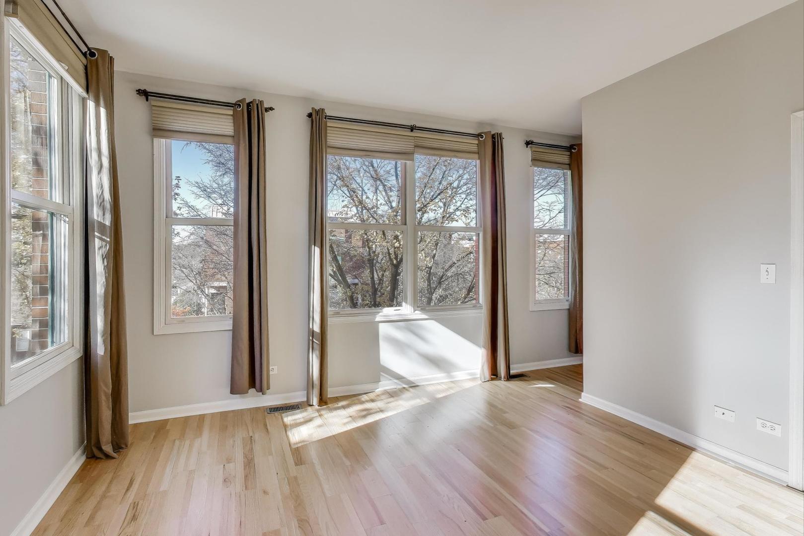 125 North Rose Street, Unit E Palatine, IL 60067 - Photo 14 of 28 an empty room with wooden floor and windows