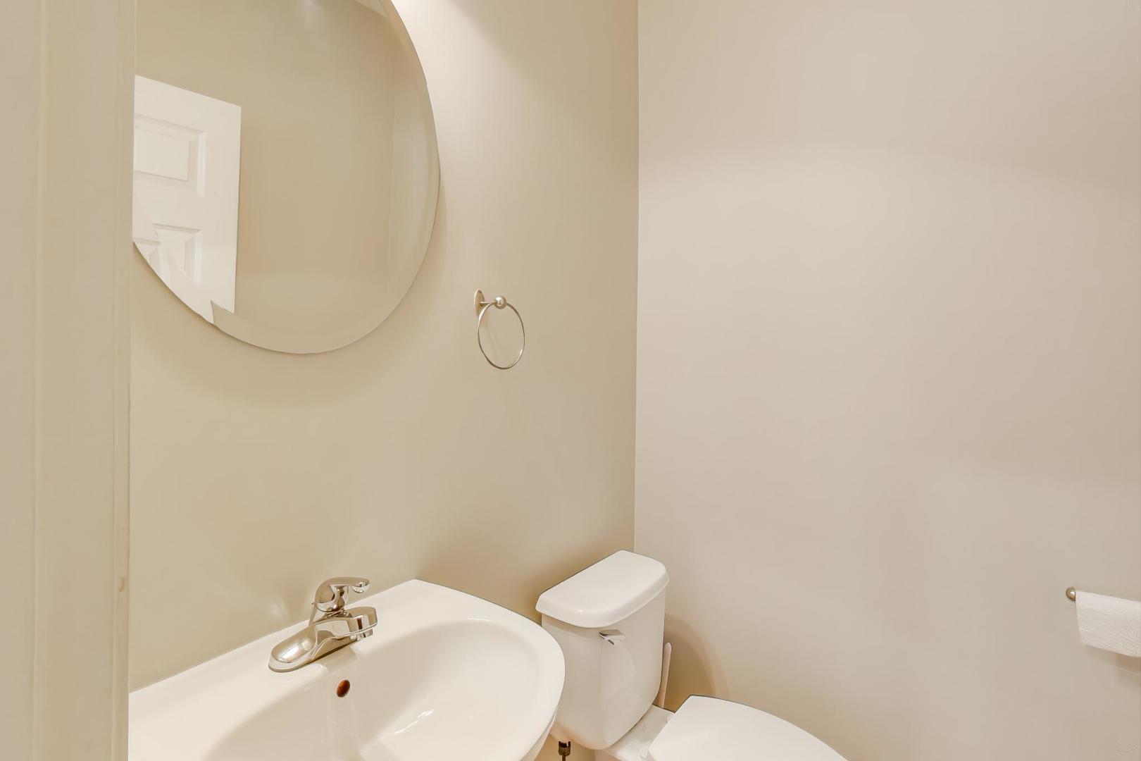 125 North Rose Street, Unit E Palatine, IL 60067 - Photo 27 of 28 a bathroom with a sink mirror and toilet