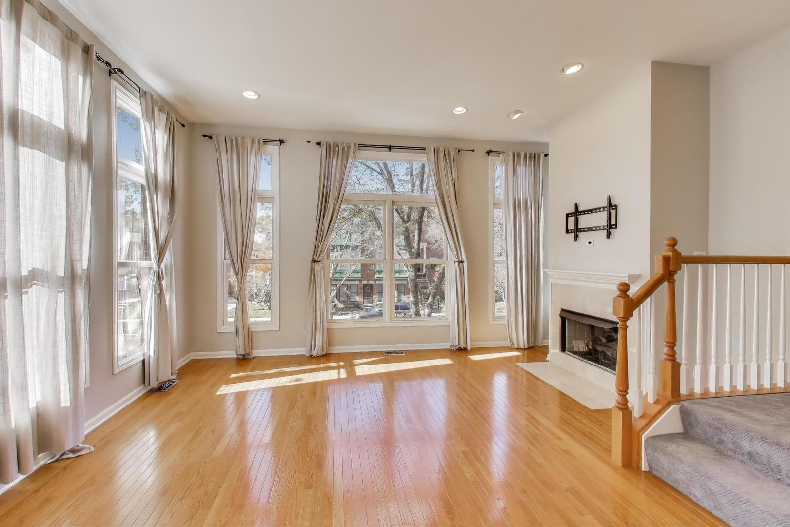 125 North Rose Street, Unit E Palatine, IL 60067 - Photo 3 of 28 a view of an empty room with wooden floor and a window