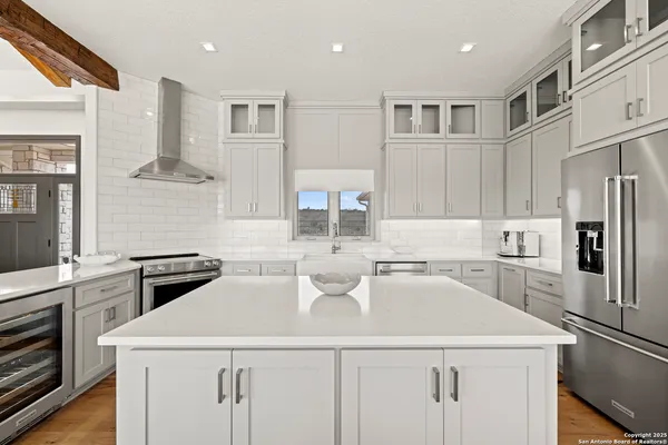a spacious bathroom with a double vanity sink a mirror and a bathtub