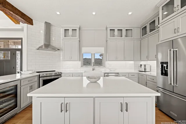 a spacious bathroom with a double vanity sink a mirror and a bathtub