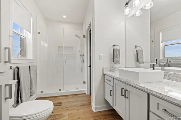 a view of a terrace with a bench and some trees