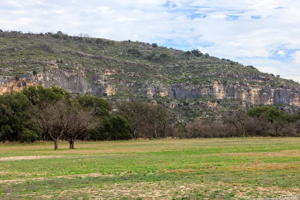a living room with furniture a flat screen tv and a table