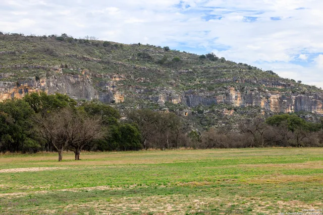 a living room with furniture a flat screen tv and a table