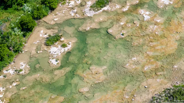 a backyard of a house with a yard and outdoor seating