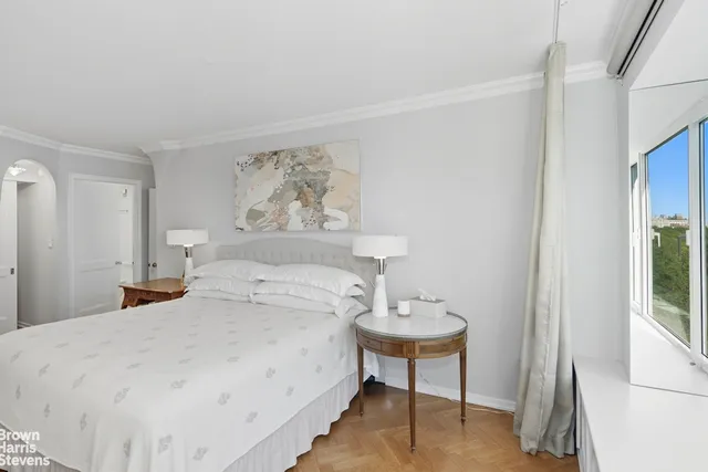 a bedroom with furniture and a flat screen tv