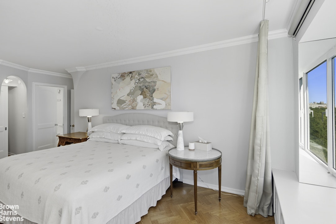 1050 5th Avenue, Unit 15C Manhattan, NY 10028 - Photo 10 of 15 a bedroom with a bed and a painting on the wall