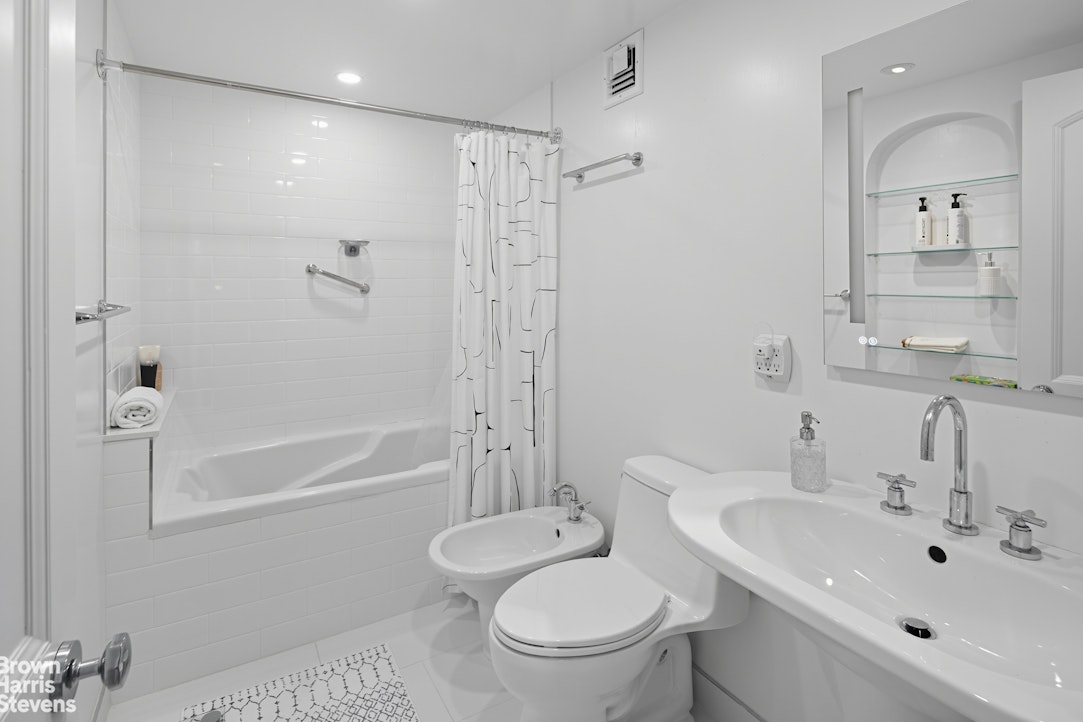 1050 5th Avenue, Unit 15C Manhattan, NY 10028 - Photo 12 of 15 a bathroom with a sink toilet and shower