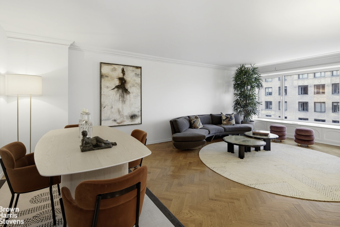 1050 5th Avenue, Unit 15C Manhattan, NY 10028 - Photo 2 of 15 a living room with furniture and a table