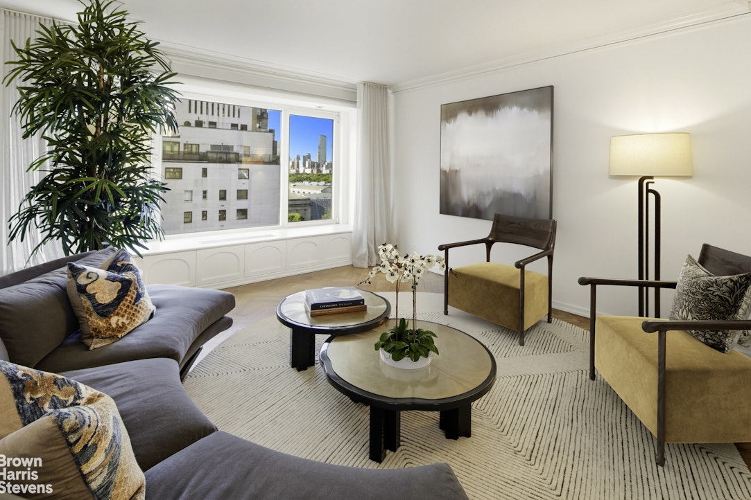 1050 5th Avenue, Unit 15C Manhattan, NY 10028 - Photo 3 of 15 a living room with furniture and a potted plant