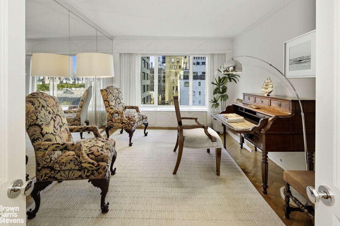 1050 5th Avenue, Unit 15C Manhattan, NY 10028 - Photo 7 of 15 a living room with furniture and a large window