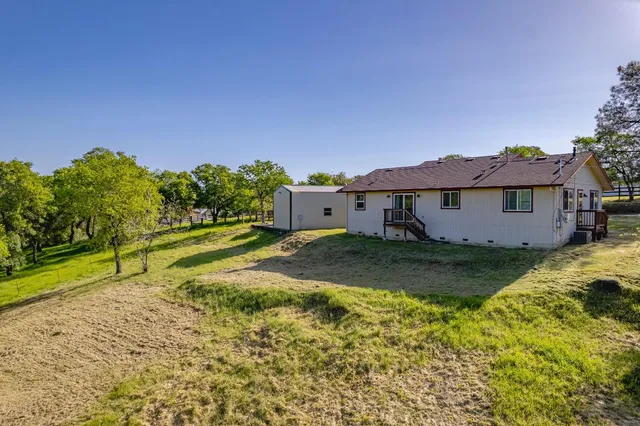 an aerial view of residential house with swimming pool