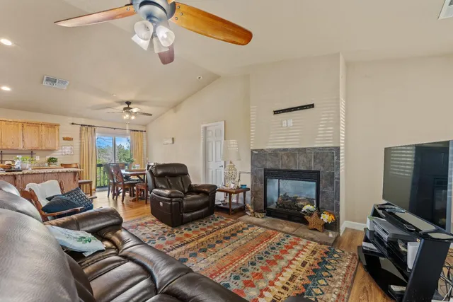 a living room with furniture a fireplace and a flat screen tv