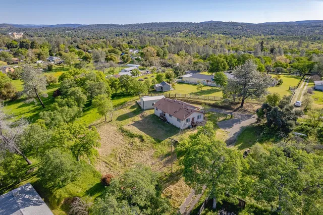a view of a lush green hillside and houses