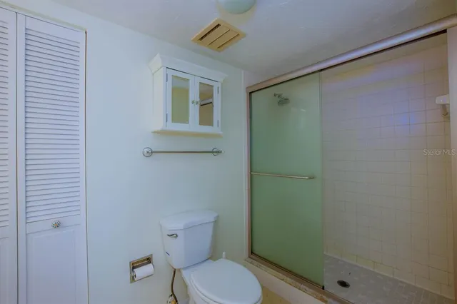 a bathroom with a toilet and a shower