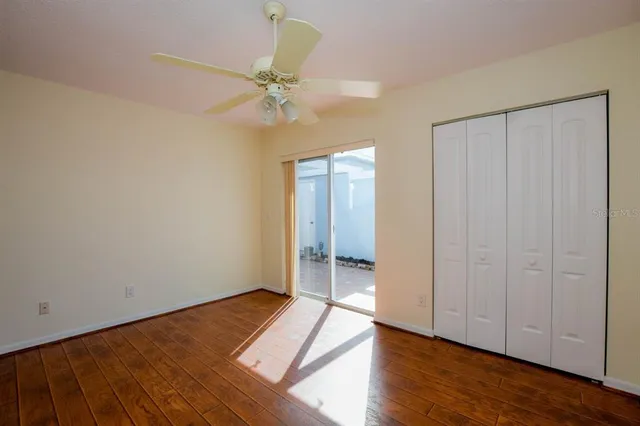 wooden floor in an empty room with a window
