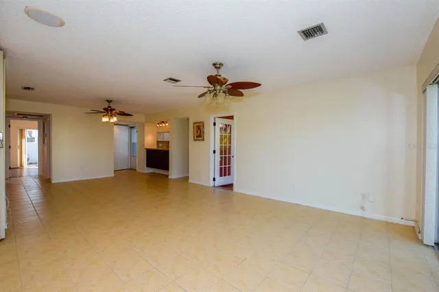 a view of empty room with ceiling fan