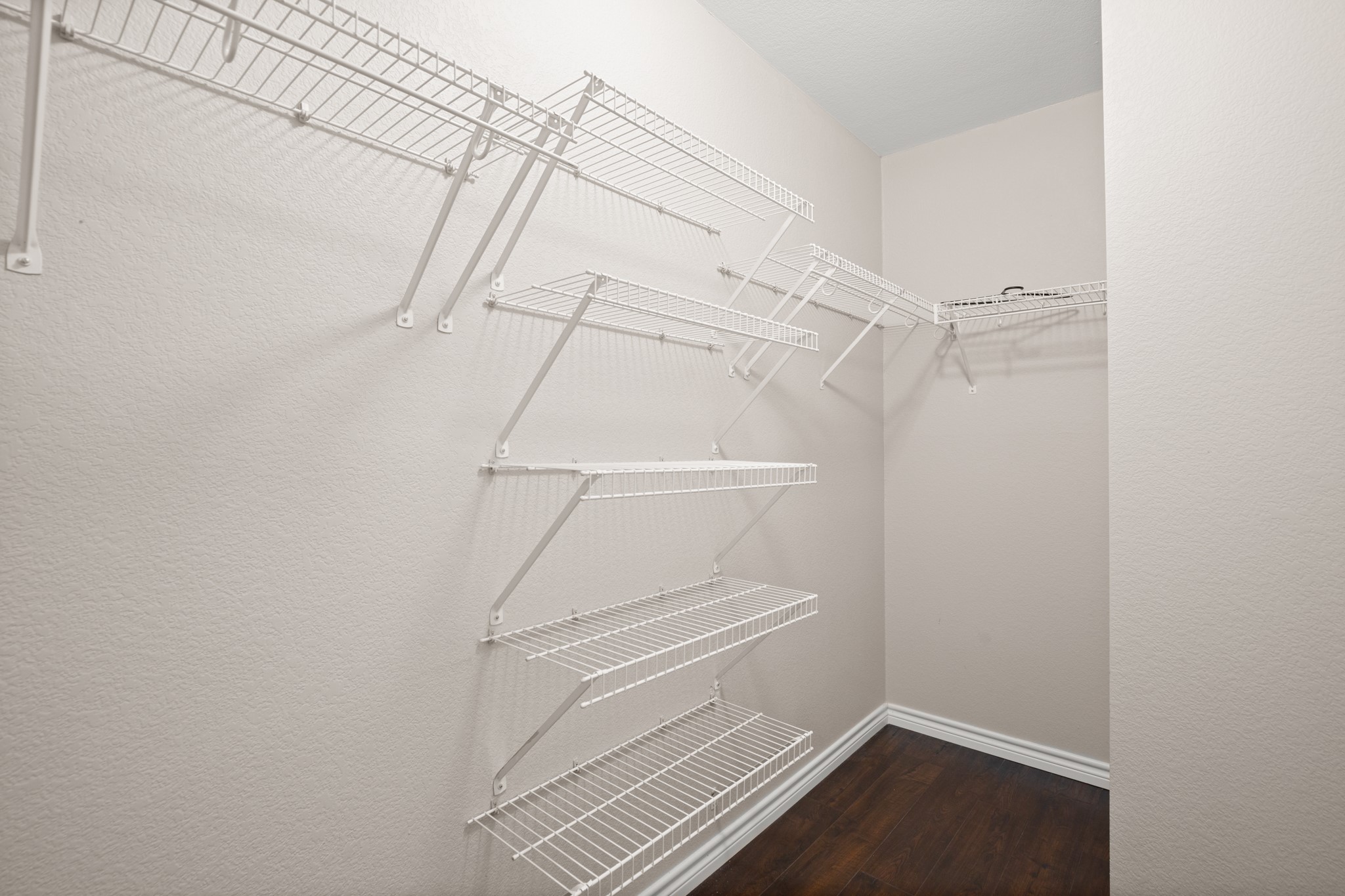 151 Sampson Kyle, TX 78640 - Photo 12 of 23 The primary suite includes a spacious walk-in closet designed for real-world functionality and easy organization.