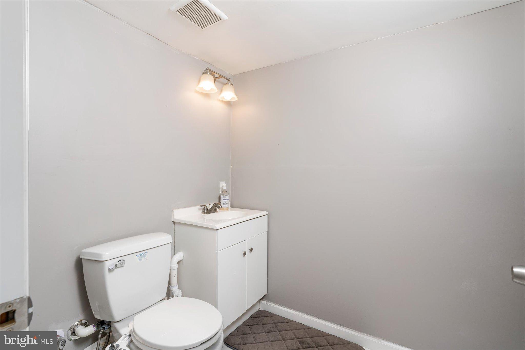617 Smith Lane Mount Holly, NJ 08060 - Photo 20 of 29 a bathroom with a toilet a sink and mirror