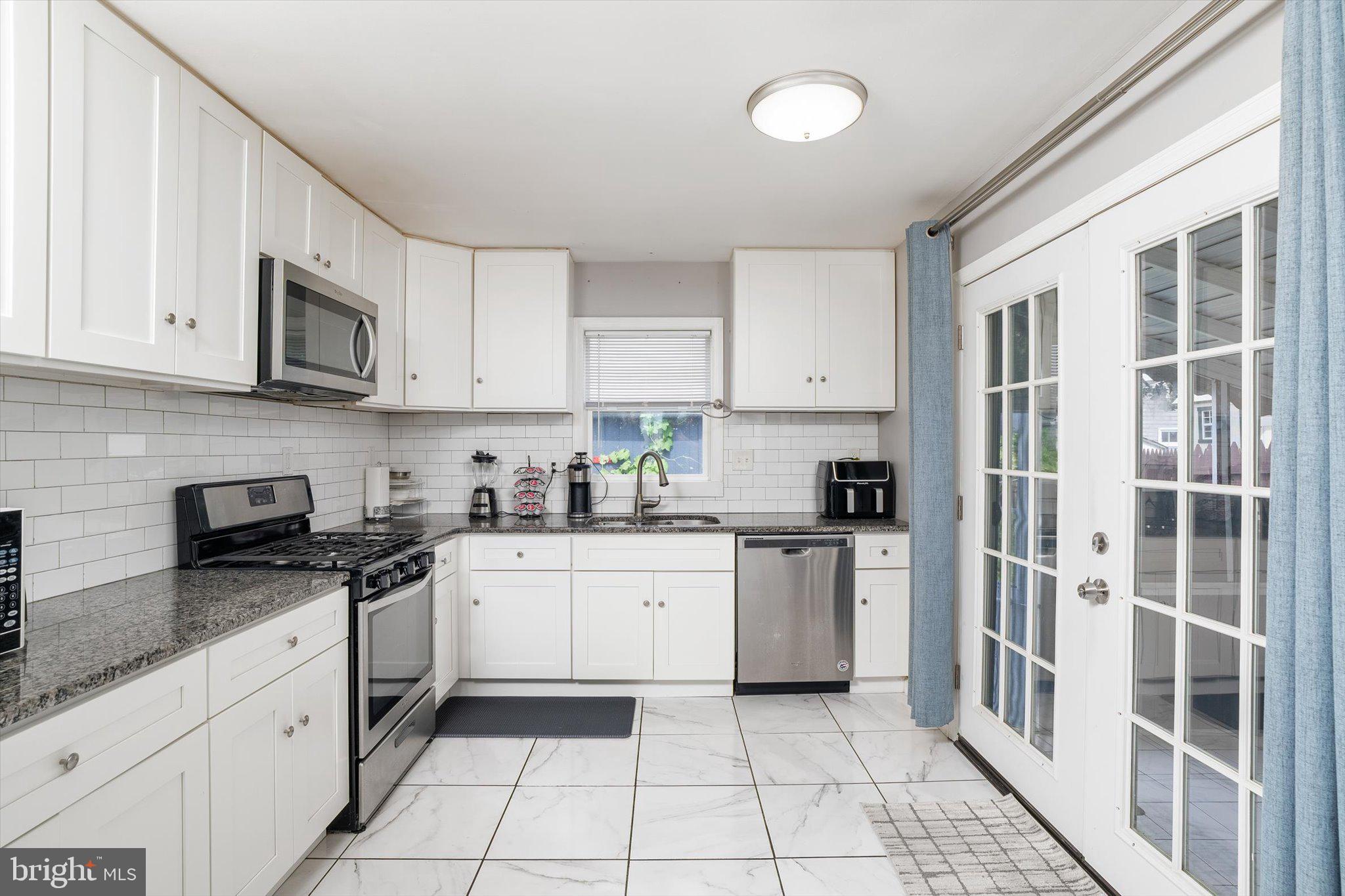 617 Smith Lane Mount Holly, NJ 08060 - Photo 7 of 29 a kitchen with stainless steel appliances granite countertop a stove sink and cabinets