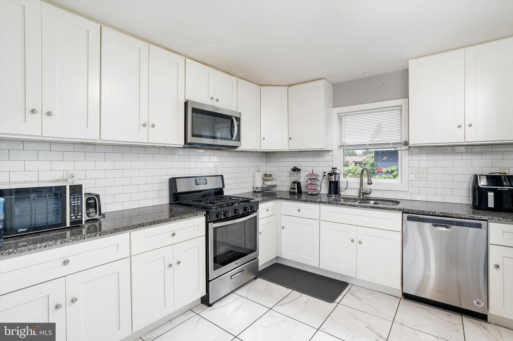 617 Smith Lane Mount Holly, NJ 08060 - Photo 8 of 29 a kitchen with white cabinets stainless steel appliances and sink