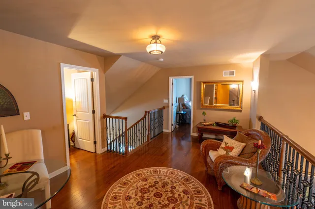a living room with fireplace furniture and a wooden floor
