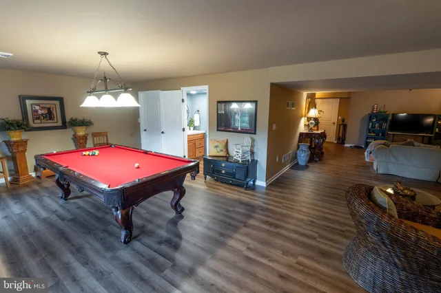 a room with pool table and flat screen tv