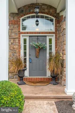 a front view of a building with plants