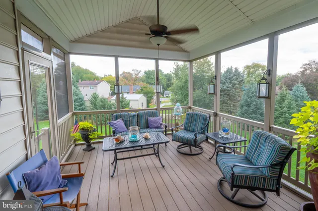 a view of a chair and tables in the balcony